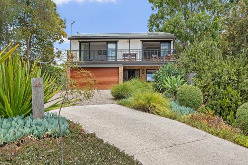 a house with a walkway in a garden at Port of Call - Port Willunga - C21 SouthCoast Holidays in Port Willunga