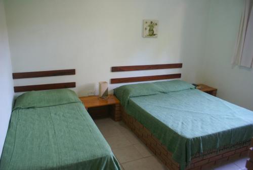 Una cama o camas en una habitación de Pousada A Cor Do Sol