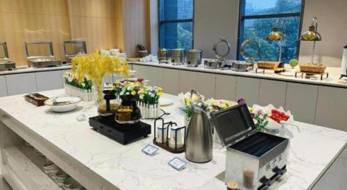 a room with a table with flowers on it at Lavande Hotel Yichang Railway East Station Branch in Yichang