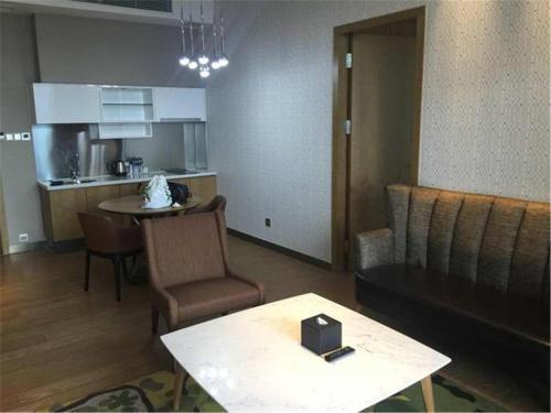 a living room with a couch and a table at The Summit Hotel in Zhongshan