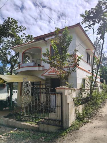 a white house with a fence in front of it at Shevaroyen villa yercaud in Yercaud