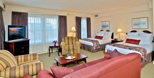 a hotel room with two beds and a couch at Historic Anchorage Hotel in Anchorage