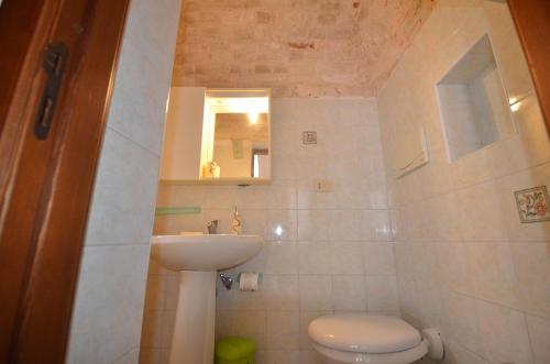 a small bathroom with a toilet and a sink at I Trulli Di Ottavio in Alberobello