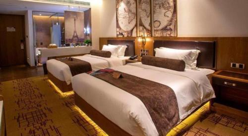a hotel room with two large beds in it at James Joyce Coffetel· Wuhan Wangjiawan Taojialing Metro Station in Wuhan