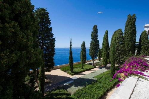 a view of a park with trees and flowers at Luxury Apartment Palais Maeterlinck in Nice