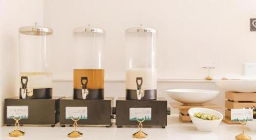 a room with a group of candles and bowls at City Comfort Inn Foshan Sanshui Datang in Xingrenbi