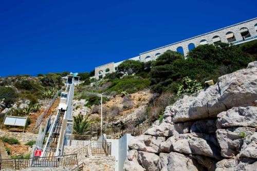 a building on top of a hill with a mountain at Luxury Apartment Palais Maeterlinck in Nice
