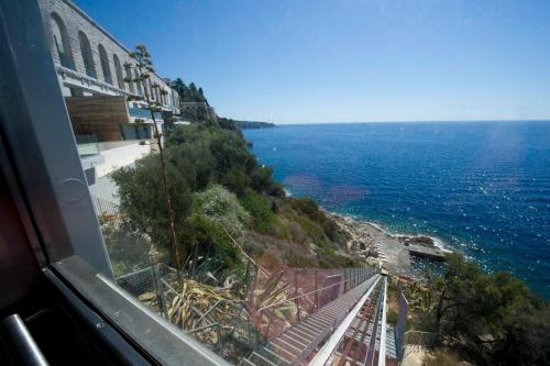 a view of the ocean from a train window at Luxury Apartment Palais Maeterlinck in Nice