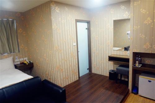 a bedroom with a bed and a sink and a mirror at Every Day Hot Spring Hotel in Jiaoxi