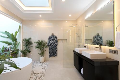 a bathroom with two sinks and a large mirror at Villa Mia Seminyak - Boutique Villas - I in Seminyak