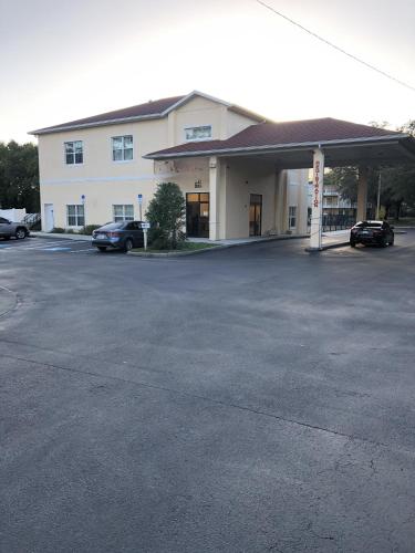 a parking lot in front of a building at Green Palms Extended Stay in Kissimmee