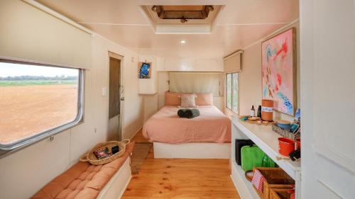 a small bedroom with a bed and a window at Meralda Station in Cobar