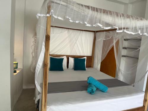 a bedroom with a bunk bed with a blue teddy bear at Olympus House in Mirissa