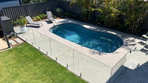 a swimming pool with two chairs in a backyard at Only The Best Will Do - Pool Wifi in Hawks Nest