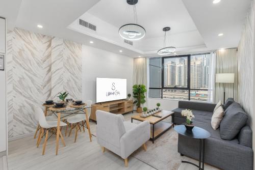 a living room with a couch and a table at Ultimate Stay - Modern 1BR with City View Rooftop Pool Access in Dubai