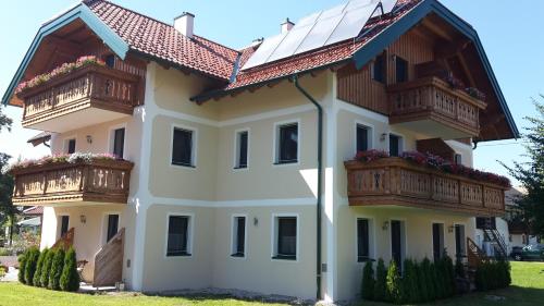 a white house with balconies on top of it at Pension Ballwein in Salzburg