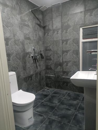 a bathroom with a toilet and a sink at Le Petit Paradis Nepal Terrace & Mountain View in Pātan