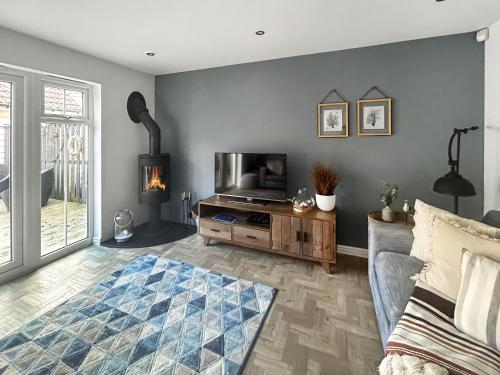 un salon avec une télévision et un canapé et une télévisionvictericterictericter dans l'établissement Dory, à Camber