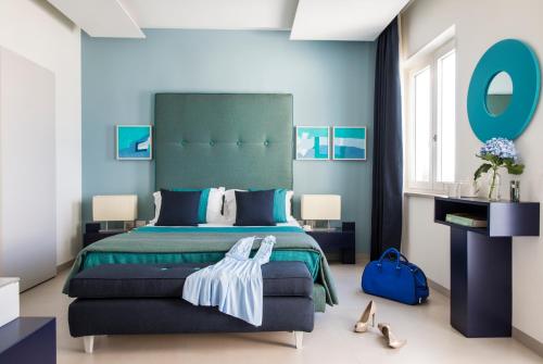A bed or beds in a room at Villa Gervasio Rooms