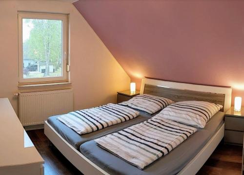 a bed with two pillows on it in a bedroom at Unter den Kiefern 62 in Röbel
