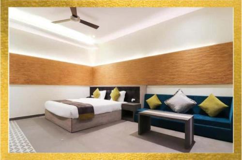 a bedroom with a bed and a bench in it at Kingston Resort in Kānpur