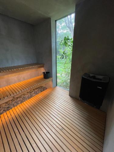 a empty room with a window and a television at TIMeSCAPE -hakone- in Miyanoshita