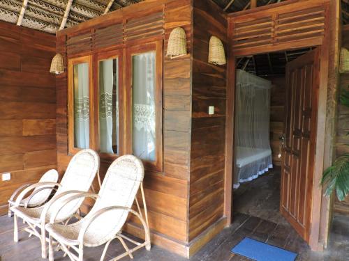 a group of chairs sitting on a porch at Cinnabar Resort in Tangalle