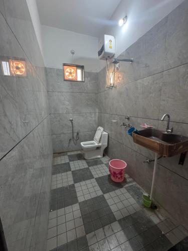 a bathroom with a sink and a toilet at Takery Resort in Chittaurgarh