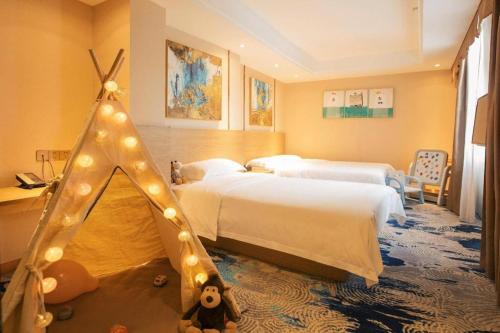 a bedroom with two beds and a iguana tent at T Social Hotel Guangzhou Railway Station Branch in Guangzhou