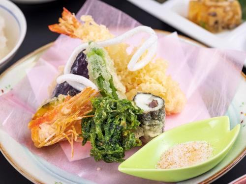 a plate of food with sushi and vegetables on it at Sansuien in Kochi