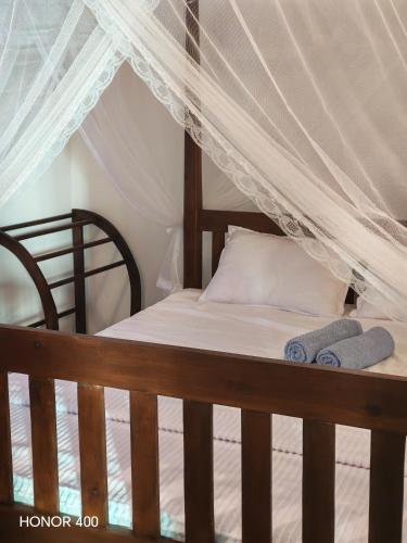 a bed with two towels sitting on top of it at Hilltop Haven in Mirissa