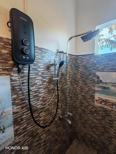 a bathroom with a shower in a wall at Hilltop Haven in Mirissa