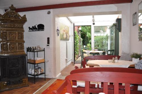 ein Restaurant mit einem Kamin sowie Tischen und Stühlen in der Unterkunft Gästehaus Kleiner Muck in Glückstadt