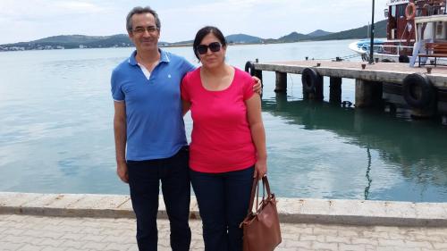 a man and a woman standing next to a dock at Eren Villa in Sapanca