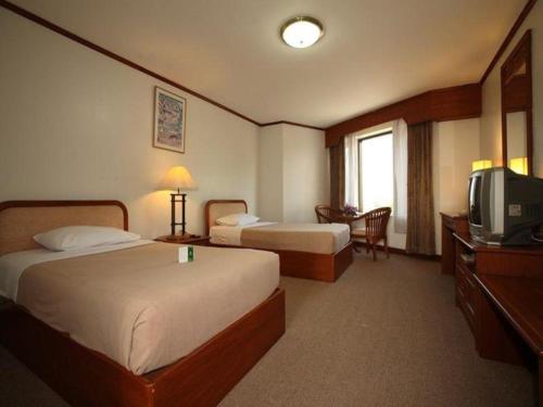 Una cama o camas en una habitación de Royal Diamond Hotel