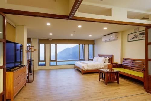 a bedroom with a bed and a large window at 隱山居 海景包棟2-10人 in Jiufen