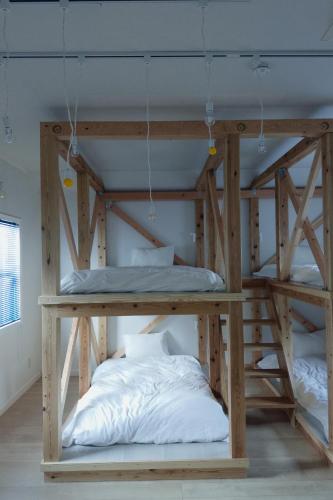 a bunk bed in a room with two bunk beds at やまぽっちYamapochi Cottage in Hakuba