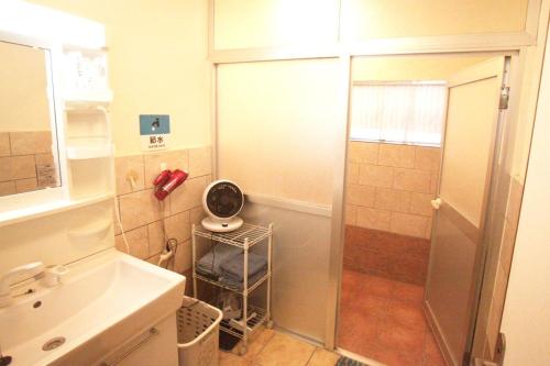 a small bathroom with a shower and a sink at 2F - Vacation STAY 41669v in Okinawa City