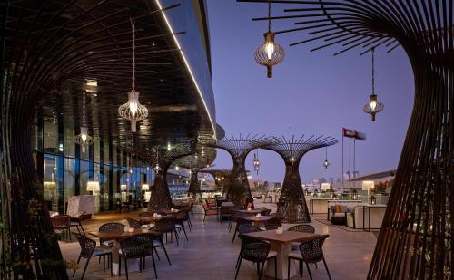 a row of tables and chairs in a building with lights at Grand Hyatt Abu Dhabi Hotel & Residences Emirates Pearl in Abu Dhabi