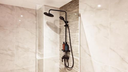 a shower with a shower head in a bathroom at Mali Villa 57 in Patong Beach