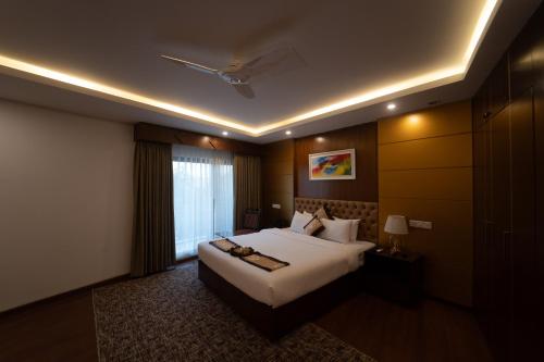 a hotel room with a bed and a window at Paragon Hotel & Resort in Sreemangal