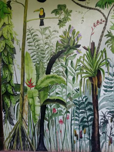 a wall with a mural of plants on it at Omega Tours Eco-Jungle Lodge in La Ceiba