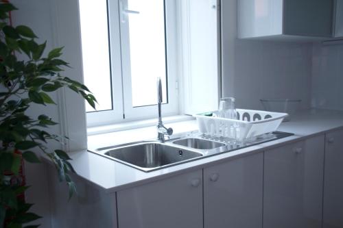 a kitchen counter with a sink and a window at Carvalhal Old Town in Funchal