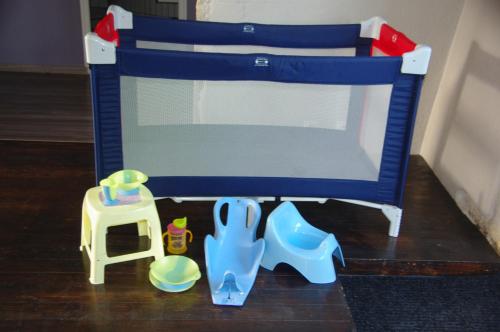 a blue playset with a stool and a toy crib at Appartement La Poulotte in Couchey