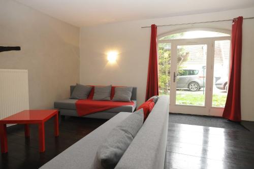 a living room with a couch and a bed at Appartement La Poulotte in Couchey