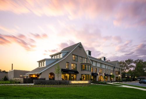 a large white building with a sunset in the background at The Inn At Swarthmore in Swarthmore