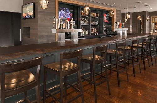 a bar with brown stools in a restaurant at The Inn At Swarthmore in Swarthmore