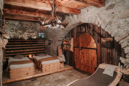 a room with two beds and a chandelier in a building at Ansitz Gurtenhof in Tesimo