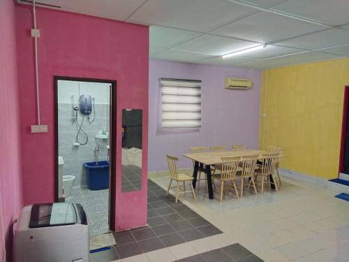 a dining room with a table and chairs at Village House With River View And Karaoke 8 to10 Pax in Jeram