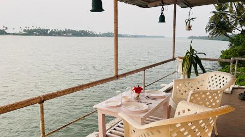 a table and chairs on the deck of a boat at Palm Breeze in Udupi